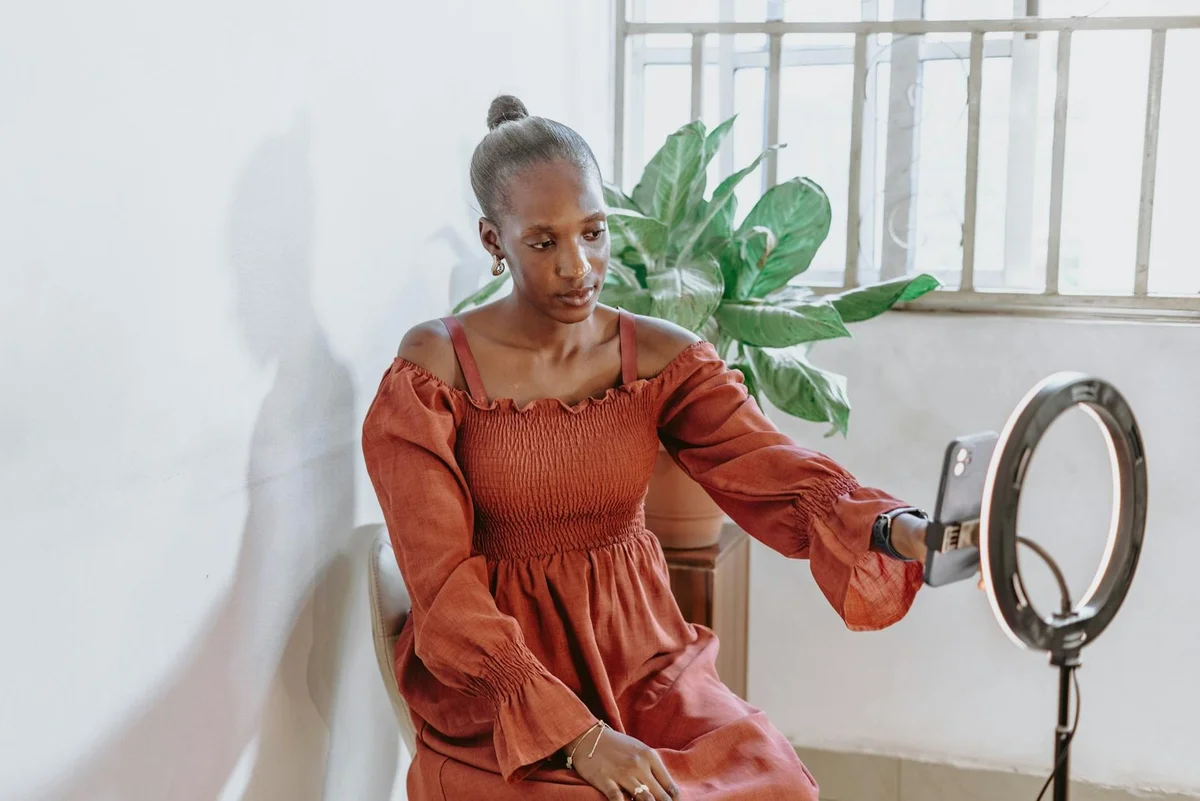 How to Optimize Your TikTok for Search: SEO Step-by-Step Tut... — Fashionable woman vlogging indoors with ring light and phone in Abuja, Nigeria.