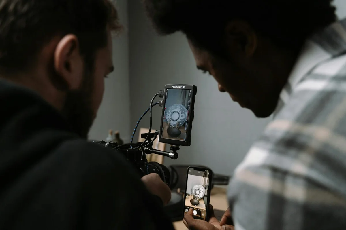 How to Choose the Right TikTok Content Format for Every Idea — Two men use cameras and smartphones to capture a close-up video in a studio sett