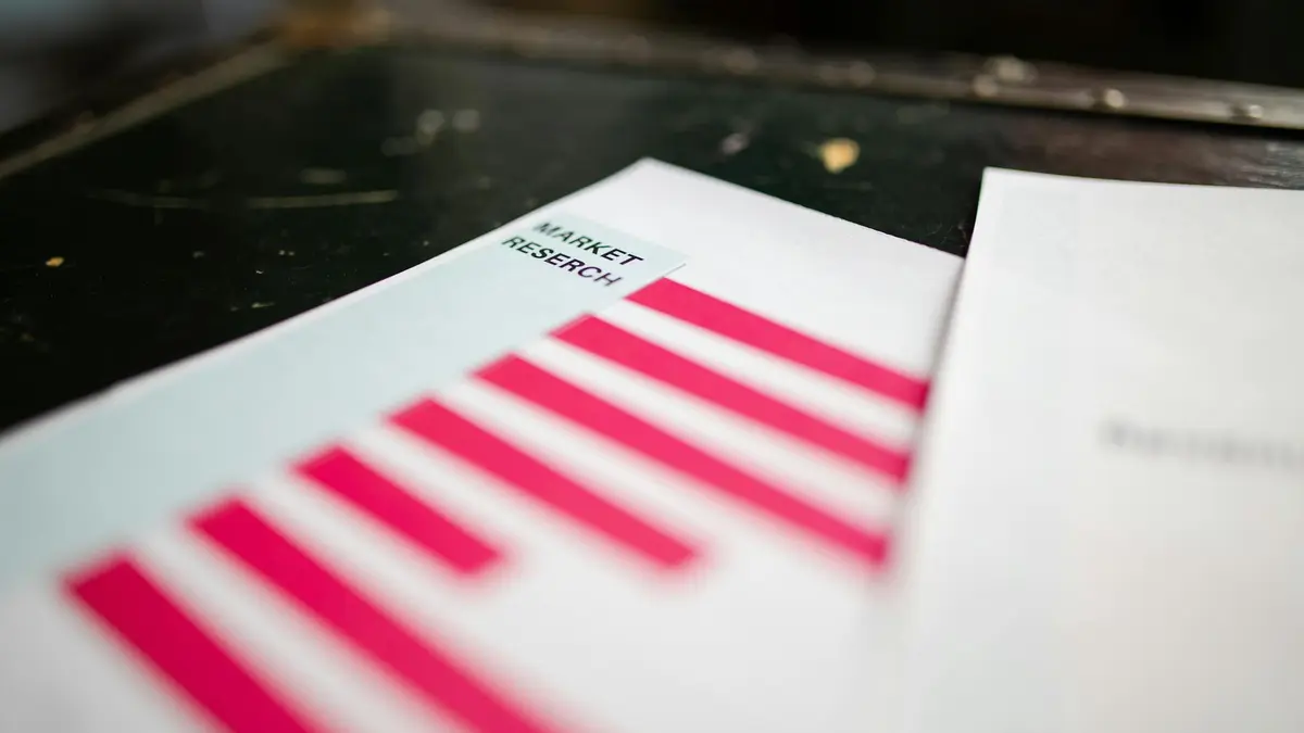 A detailed close-up of a market research document featuring a bar graph and a focus on market trends